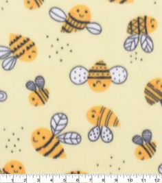 a ruler is next to a yellow background with bees