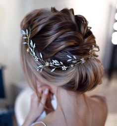 a woman wearing a hair comb with flowers in it