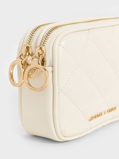 No matter what they adorn, quilted textures have the ability to instantly elevate a design, including this charming wristlet pouch. In a creamy, elegant white finish, it looks extra chic and polished. The gold-tone metallic accents further refine the design, giving it a sophisticated vibe. Whether you are heading out for a quick lunch or running a short errand, this compact yet functional wristlet pouch will be the perfect companion. Wristlet Pouch, Quick Lunch, Charles Keith, Metallic Accents, Gold Tones, Matter, Pouch, Running, Cream