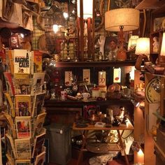 a room filled with lots of different types of items and lights on the wall above it