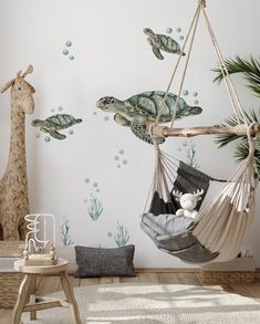 a child's room with a turtle and giraffe decals on the wall