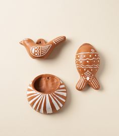 three ceramic birds sitting next to each other