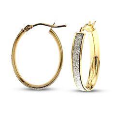 These gorgeous Italian-made hoop earrings for her feature an oval design embellished with glitter and white enameled finish. The 14K yellow gold earrings secure with snap-lock backs. Sparkling Yellow Gold Round Hoop Earrings, Sparkling Yellow Gold Hoop Jewelry, Formal Gold Sparkling Hoop Earrings, Yellow Gold Sparkling Hoop Earrings As Gift, Gold Sparkling Hoop Earrings For Formal Occasions, Gold Sparkling Hoop Earrings For Formal Events, Sparkling Yellow Gold Hoop Earrings For Gifts, Oval Hoop Earrings With Shiny Finish For Anniversary, Gold Glitter Round Earrings