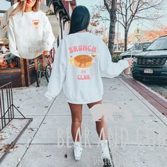 Elevate your brunch attire with the "Brunch Club" Crewneck--a nod to the leisurely pursuit of good times and great food. Whether you're brunching with friends or simply soaking in the weekend vibes, this sweatshirt is the perfect companion for embracing the laid-back spirit of the brunch lifestyle. *These unisex heavy blend crewneck sweatshirts are pure comfort. These garments are made from polyester and cotton. This combination helps designs come out looking fresh and beautiful. The collar is r Oversized Tops For Fall Brunch, Oversized Fall Top For Brunch, Oversized Cotton Top For Brunch, Long Sleeve Graphic Print Tops For Brunch, The Weekend Vibes, Brunch Attire, Crewneck Aesthetic, Brunch Club, Grunge Hippie