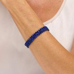 Jay King Faceted Blue Lapis Woven Bead Stretch Bracelet  Tiny, faceted blue lapis beads, handcrafted into a woven design, give this easy-to-wear stretch bracelet a fun, fashionable touch of dimension and color. From Jay King.       Approx. 7-1/4"L x 1/2"W; fits 7" to 7-1/2" wrist     Stamped .925 (quality tag only)     Stretch bracelet has 3mm faceted, round blue lapis beads woven together with jeweler's elastic   Stone Information       All sizes and weights approximate     Stabilized Blue Lapis - Faceted round (3mm); mined in Afghanistan Adjustable Lapis Lazuli Beaded Bracelet With Faceted Beads, Blue Beaded Braided Bracelets For Jewelry Making, Color Bands, Blue Lapis, Woven Design, Brand Me, Beaded Stretch Bracelet, Bead Weaving, Stretch Bracelet