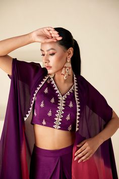 Elevate your festive wardrobe with the Radiant Orchid Ombre Ensemble a fusion of elegance and modern flair. This set features a pre-draped skirt and a hand-embroidered blouse, complemented by an airy ombre cape that transitions from rich purple to delicate pink. Evening Cape Sets Made Of Georgette, Eid Evening Sets With Cape Sleeves, Evening Sets For Eid With Cape Sleeves, Evening Sets With Cape Sleeves For Eid, Eid Party Cape Sets, Designer Georgette Cape Set, Georgette Sets With Cape Sleeves For Eid, Festive Georgette Cape Sets, Designer Pre-draped Saree With Cape Sleeves For Eid