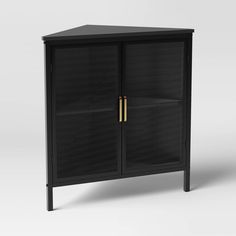 a black cabinet with two doors and gold handles