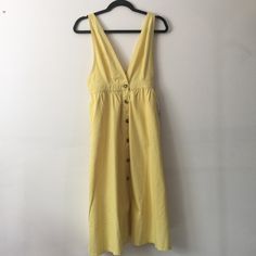 Butter Yellow Pinafore Dress From Urban Outfitters. Brand New With Tags. I Purchased Last Season And Never Wore It. The Color Is Richer Than It Looks In The Pictures. A Really Sweet Dress. 100% Cotton. Has Pockets!! And Tortoiseshell Buttons. Great For Any Season (Layered With Tights And A Turtleneck Or Chunky Sweater!) Measurements When Laying Flat: Ptp 16” Stretched Waist 14” Hips Up To 22” Length From Shoulder 44” But Straps Are Adjustable Urban Outfitters V-neck Sundress For Summer, V-neck Sundress With Buttons, Spring Sleeveless Sundress With Pockets, Spring Sundress With Pockets, Spring Sundress With Buttons For Casual Wear, Spring Sundress With Buttons, Spring Sundress With Button Closure, Spring Dress Down Sundress With Buttons, Sleeveless Midi Dress With Button Closure For Brunch