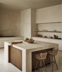 a large kitchen island with two stools in front of it