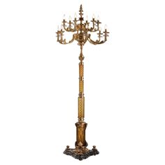 an ornate gold and crystal candelabra with five lights on the base,