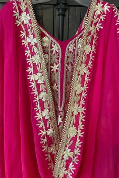 This beautifully designed Hot Pink Hand Embroidered Silk Anarkali Dress is crafted with intricate Tilla and Gotta work, creating a stunning choice for any special event. This dress includes a matching silk churidar bottom and a 2.5 meter pure chinon silk embroidered dupatta chunni, perfect for weddings and parties. Silk Chinon Silk Dupatta 2.5 meter Lined Hand Embroidered String tie back with zipper Churidar bottom Full elastic waist band Work: Handcrafted gotta work, tilla work Condition: New O Pink Chanderi Dress With Intricate Embroidery, Traditional Pink Dress With Resham Embroidery, Festival Chanderi Kaftan For Party, Anarkali Gota Work Kaftan For Wedding, Bollywood Style Wedding Kaftan With Gota Work, Pink Zari Work Kaftan For Party, Pink Maxi Salwar Kameez With Intricate Embroidery, Wedding Chanderi Kaftan With Mirror Work, Intricate Embroidery Kaftan For Diwali Party