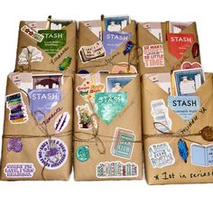 several packages wrapped in brown paper with various stickers on them, tied together and sitting next to each other