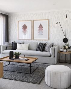 a living room filled with furniture and pictures on the wall above it's coffee table