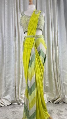 !! Designer Collection!! Beautiful neon green Pre pleated ready to wear 1 min saree with hand embroidered bead work blouse and belt. Pre drapped sari.Perfect outfit for Asian wedding ceremonies or festivals. It is very comfortable and light weight yet stylish and elegant. Details Blouse Fabric: Georgette Inner : Padded and Crepe lined Colour: green Sleeves: Sleeveless with additional cloth for sleeves Embroidery : sequins, beads hand embroidery  Saree Fabric: Chiffon and net Colour : lime green Green Designer Choli With Traditional Drape, Designer Green Choli With Traditional Drape, Green Choli With Traditional Drape For Designer Wear, Green Designer Wear Choli With Traditional Drape, Green Pre-draped Saree With Dupatta, Green Pre-draped Saree With Self Design For Diwali, Designer Semi-stitched Draped Saree, Green Anarkali Style Pre-draped Floor-length Saree, Bollywood Style Draped Saree With Zari Work