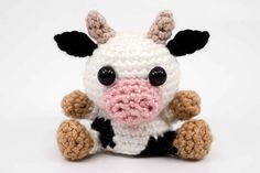 a crocheted stuffed cow with black and white stripes on it's face