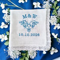 a blue and white wedding handkerchief with the word mr and mrs on it surrounded by flowers