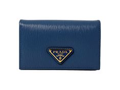 This vibrant blue Prada card holder is an effortlessly chic way to store credit cards, business cards, coins, and small objects. The wallet's conveniently small size makes it easy to keep in your purse or pocket. Three card slots and a main pocket mean organizing is a breeze.     Model: 1MC122  Cobalto blue leather  Gold-tone hardware  Snap closure  Card holder/wallet  Signature Prada Triangle logo   Measurements: 4.5" x 1.5" x 2.5" (LWH)  Includes authenticity cards and Prada box   Made in Ital Modern Wallets With Logo Plaque For Everyday, Formal Blue Bags With Card Slots, Designer Blue Bags With Card Slots, Blue Designer Bags With Card Slots, Designer Blue Bifold Wallets, Designer Blue Wallet For Everyday Use, Designer Blue Wallets For Business, Designer Blue Business Wallets, Designer Blue Card Holder For Everyday