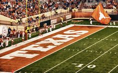 an orange and white football field with players on it