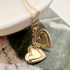 A romantic and timeless locket in a modern, dainty silhouette. The functional heart locket hangs upon a delicately twisted chain. Versatile enough to simply be worn solo or layered as the perfect compliment to your favorite necklaces. Adjustable between 18-21". Locket measures 1/2". Our materials make for an amazing, high quality, seamless, jewelry piece with longevity. Our necklaces are plated with 18k gold, 18k rose gold, or rhodium and finished with a protective coating. A little secret we’ll Golden Locket, Gold Locket Necklace, Twisted Chain, Bar Pendant Necklace, Heart Locket Necklace, Daisy Necklace, Rose Quartz Necklace, Gold Locket, Silver Lockets