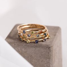 Celebrate all the favorites in your life! The Five Birthstone Stacker is a simple, solid gold band that features five colored stones of your choice. This stacker ring is the perfect way to show off your birthstone, anniversary stone, or just a colored stone you love right alongside your other favorite CTWF pieces. The Five Birthstone Stacker is the easiest way to add color to your ring stack, while telling a sweet story at the same time! Rings With Stones, Stacker Rings, Bespoke Engagement Ring, Solid Gold Band, Ring Stack, Colored Stones, Colored Stone, Jewelry Studio, Signature Jewelry