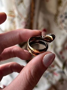 A sumptuous, incredible snake ring with blue, green, white, and red enamel, this outstanding ring is a fine example of the 1960's revival of Victorian art in jewelry. This specific ring takes the form of a gorgeous Victorian-esque snake with her open mouth, shining teeth, and inquisitive eyes, slithering up off of the finger to greet her wearer, or perhaps their conversation partner with her wide grin. This vintage example boasts a 14k yellow gold snake with many beautiful enameled details, and Antique Snake-shaped Yellow Gold Jewelry, Unique Hallmarked Snake Ring For Formal Occasions, Unique Yellow Gold Snake Ring, Antique Snake Ring As Gift, Vintage Snake-shape Jewelry For Formal Occasions, Vintage Yellow Gold Snake Jewelry, Elegant Hallmarked Snake Ring, Unique Open Ring Snake Ring For Anniversary, Vintage Snake-shaped Jewelry Gift