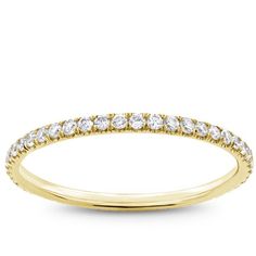 a yellow gold wedding band with diamonds