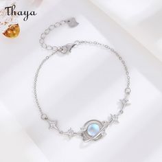 Introducing the stunning Thaya 925 Silver Jewelry Collection, featuring a beautiful combination of moonstone and zircon inlays. Available in animal/zodiac, floral, and geometric styles, each piece is carefully crafted using high-quality electroplating. Designed for women, this collection features pure silver inlaid moonstone and zircon with a chain length of 15.5+3cm and a weight of approximately 3.07g. Upgrade your jewelry game with Thaya's elegant and unique designs. Celestial Sterling Silver Bracelets, Celestial Silver Jewelry With Birthstone, Celestial Silver Bracelets With Moon Phase, Silver Moon-shaped Sterling Silver Bracelet, Celestial Silver Moon Phase Bracelets, Elegant Silver Bracelets With Moon Phase, Elegant Silver Moon Phase Bracelet, Silver Moonstone Symbolic Jewelry, Silver Symbolic Moonstone Jewelry