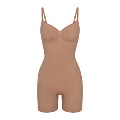 The sculpting bodysuit all over your feed, updated for an even better fit. Wear this mid thigh bodysuit for strong compression and targeted control along the waist, tummy, and legs, plus butt-enhancing pockets for a lifted look. Features front pique stitching along the front and sides for a defined and supported bust, adjustable straps, a wide crotch for added coverage, and a cotton gusset. Fits true to size. | SKIMS Mid Thigh Bodysuit | Medium Neutral | Seamless Sculpt Tshirt Bodysuit, Sculpting Bodysuit, Plunge Bodysuit, Strapless Bodysuit, High Neck Bodysuit, Mock Neck Bodysuit, Blue Bodysuit, Sheer Bodysuit, Cami Bodysuit