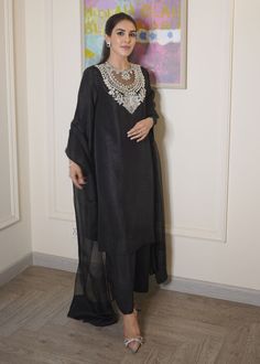 Black raw silk dress has beautiful sequin and cutdana embroidery over the neck, paired with orgenza dupatta. This dress is fully lined. ✨ You can wear this super stylish dress in any of your party, office and gathering ✨This dress can be customise in any other colour and in all size also ,please contact us regarding any changes if you want.We will make this dress as per your choice. ✨We take little longer time to manufacture as we take lot of care while manufacturing the outfit. So that our customers get fully satisfied when they receive the dress. Your patience is important ✨There may be slight colour difference due to high quality camera resolution and other filters. Rest everything will be same.  🌸Care instructions Dry clean only Eid Organza Floor-length Palazzo Set, Floor-length Organza Palazzo Set For Eid, Elegant Semi-stitched Silk Palazzo Set, Long Sleeve Organza Salwar Kameez With Mirror Work, Designer Silk Kurta With Sheer Dupatta, Designer Organza Sharara With Straight Kurta, Designer Organza Palazzo Set For Eid, Organza Palazzo Set For Eid Party, Party Organza Palazzo Set With Long Sleeves