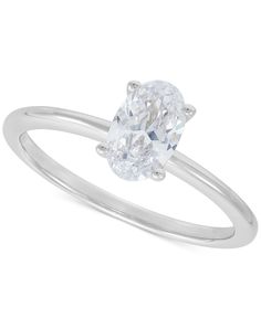 a white gold ring with an oval cut diamond