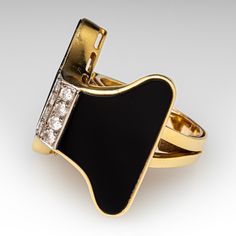 The vintage bow motif ring is centered with eight (8) bead set round brilliant cut diamonds. The diamonds are flanked to each side by bezel set custom polished black onyx. The onyx measure 25mm X 14mm. The ring measures 25.5mm at the top, rises 11.9mm above the finger, tapering to 3.9mm wide and 1.4mm thick at the base of the shank. The ring is crafted from 18k yellow gold and currently fits like a size 7.25 with a spring ring. Please note the shank is slighty out of round, and the spring ring can be removed during re-sizing. We have left this ring unpolished to highlight its lovely patina. Statement Rings Diamond, Bead Set, Round Brilliant Cut Diamond, Brilliant Cut Diamond, Bezel Setting, Statement Ring, Spring Rings, Black Onyx, The Vintage