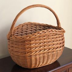 A real beauty, this rustic mid-20th century market basket features intricate handwoven designs, a braided rim, and French randing at the bottom. It is a sturdy, tall, and deep basket, making it perfect for carrying larger fruits and vegetables, as well as wine and other bottles. Also doubles as a lovely display piece.  Basket interior measures roughly 15” (w) x 9”(d) x 10” (h). Basketry Products, Willow Weaving, Basket Making, Basket Case, Market Basket, Market Baskets, French Decor, Accessory Organization, Real Beauty