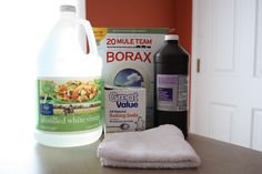 the contents of a dishwasher sitting on top of a counter next to a bottle of cleaner