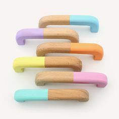 four wooden handles with pastel colors on them