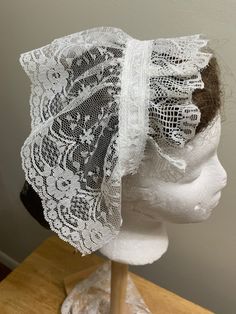 Hand made. Victorian Day Caps can be custom made. The Day Cap consists of white embroidered floral and shell like design. The front consists of a gathered shell lace design and the back consists of a gathered floral lace design. There is a white ribbon attaching the front and back of the cap. There are 2 white silk ribbons to attach the day cap in back of the head. Day Caps can be hand washed and drip dry. Day Caps were worn under bonnets, during dinners, balls, and special occasions. Elegant Lace Bonnet With Lace Trim, Fitted White Bonnet With Lace Trim, Adjustable Lace Wedding Bonnet, White Lace Adjustable Bonnet, White Adjustable Lace Bonnet, Wedding Bonnet With Lace Trim, White Adjustable Bonnet For Wedding, White Adjustable Wedding Bonnet, White Fitted Hat With Lace Trim