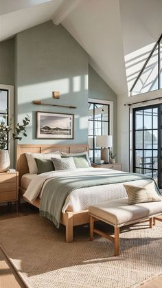 a bedroom with a large bed sitting under a skylight next to a window filled with lots of windows