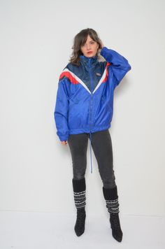 "80's Rukka zipper windbreaker. Sports jacket, rainproof. - Label: Rukka  - Era: 1990s  - Color:  blue - Fabric: shell: 100% polyamid, lining: 100% polyester - Condition: very good. clean, no tears, no rips. Ready to wear. - Tag Size: 164 - Fits size: small/medium MEASUREMENTS:  *Bust: 49.6\" (126 cm) *Waist: 43.3\" (110 cm)  *Sleeve Length: 22.2\" (57 cm) *Length: 26\" (66 cm) Model is 5.7 feet (174 cm) height." Retro Blue Nylon Windbreaker, Retro Blue Nylon Outerwear, Retro Blue Windbreaker For Fall, Blue Retro Windbreaker For Fall, Vintage Nylon Track Jacket For Winter, Blue Retro Windbreaker For Streetwear, Retro Blue Windbreaker For Streetwear, Vintage Blue Nylon Track Jacket, Vintage Blue Windbreaker For Winter