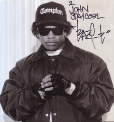 a man wearing sunglasses and a jacket with writing on it