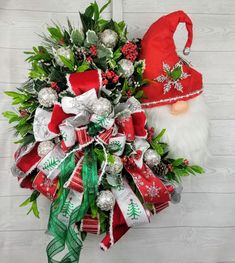 a christmas wreath with santa claus's hat on it