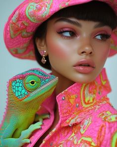 a woman wearing a pink hat with a green lizard on it's shoulder and her face