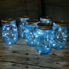 blue mason jars with fairy lights in them