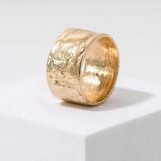 Add a touch of nature to your style with our Birch Cigar Band Ring. Crafted from real birch bark, this solid 14k yellow gold ring boasts a luxurious texture that makes a statement without being too flashy. Embrace the beauty of nature with this unique and subtle piece. Ring measures 12mm wide. We recommend sizing up at least half a size when ordering wider bands. Candle Silhouette, Silhouette Ornaments, Birch Bark, Lost Wax Casting, Baby Ornaments, Cufflinks Men, Yellow Gold Ring, Wide Bands, Cigars