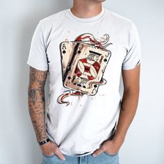 Elevate your casual style with our Poker Cards Unisex T-Shirt. Inspired by the timeless allure of the game, this tee features a captivating design showcasing intricately illustrated poker cards. Made from high-quality cotton, this t-shirt offers exceptional comfort and durability. The versatile unisex fit makes it suitable for all genders, while the classic crew neck and short sleeves add a touch of timeless appeal. Whether you're a poker enthusiast or simply appreciate the artistry of playing cards, this t-shirt is a stylish way to express your passion. Stand out from the crowd and showcase your love for the game with this unique and eye-catching tee. Graphic Print Crew Neck T-shirt For Gaming Events, Cotton Graphic Design Tops For Fan Merchandise, Cotton Sublimation Print T-shirt For Fans, Short Sleeve Graphic Design Fan Apparel Tops, Short Sleeve Graphic Fan Apparel Tops, Fan Apparel Graphic Design Short Sleeve Tops, Fan Merchandise Graphic Design Short Sleeve Shirt, Short Sleeve Graphic Tops For Fans, White Graphic Design Tops For Fan Merchandise