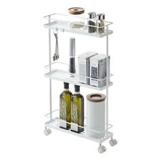 three tiered shelf with bottles and other items on it