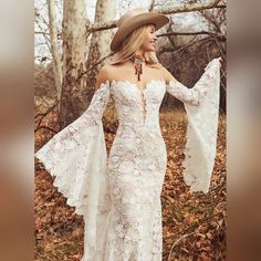 a woman in a white dress and cowboy hat