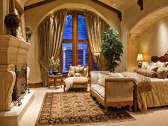 a large bedroom with an arched ceiling and windows