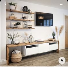 a living room with white walls and wooden shelves