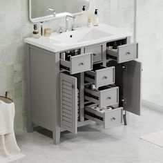 a bathroom vanity with drawers and a mirror