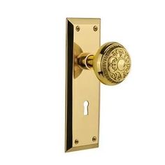 an antique brass door handle with a round knob