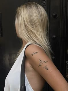 a woman with a tattoo on her arm